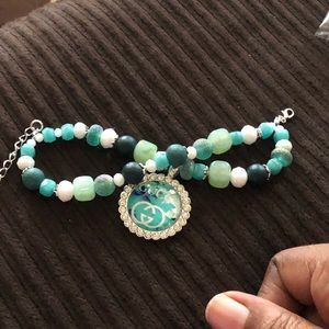 Teal  and silver tone tray charm bracelet.